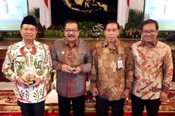 Wali Kota Mojokerto, H Mas-ud Yunus (kiri) bersama Gubernur Soekarwo usai menerima penghargaan OJK. [kariyadi/bhirawa]