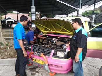 Petugas dari Bagian SDA tengah melakukan pemasangan converter kit pada salah satu Angkot.[kerin ikanto/bhirawa]