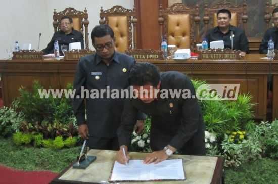 Ketua DPRD Tulungagung, Supriyono, menandatangani berita acara penetapan tujuh Raperda menjadi Perda setelah Bupati Syahri Mulyo melakukan hal yang sama dalam rapat paripurna DPRD Tulungagung, Senin (9/5) siang.