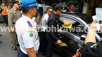 Wali Kota Malang HM. Anton menempelkan stiker larangan parkir dan mengempesi ban mobil yang melanggar parkir