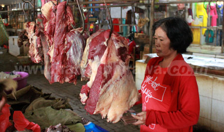 Salah satu pedagang daging di pasar Besar Kota Pasuruan, Senin (15/8). Jelang perayaan Idul Adha, harga daging sapi dan kambing di pasar tradisional di Kota Pasuruan masih stabil. [Hilmi Husain]