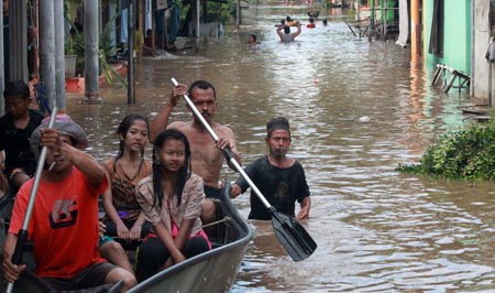 Sejumlah warga di Dusun Karangasem Kelurahan Karangketug Kecamatan Gadingrejo Kota Pasuruan menaiki perahu yang disediakan pihak BPBD Kota Pasuruan menuju tempat tinggalnya, Selasa (11/10). Di Dusun Karangasem ketinggian air banjir mencapai 1-2 meter.  [hilmi husain]