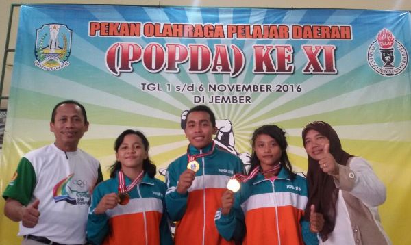 Ketua umum Persatuan Gulat Seluruh Indonesia (PGSI) Tuban, Nur Khamid bersama atlet gulat usai mengikuti Popda di Kabupaten Jember.